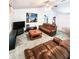 Bright living room with brown leather sofas, a coffee table, and a large TV at 5805 Danterbury Ct, Lakeland, FL 33810
