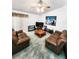 Spacious living room with brown leather sofas and a large TV at 5805 Danterbury Ct, Lakeland, FL 33810