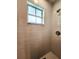 Shower stall with tiled walls and a window at 5805 Danterbury Ct, Lakeland, FL 33810