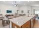 Open concept kitchen and living room with granite island and hardwood floors at 721 Bayside Blvd, Winter Haven, FL 33881