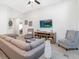 Living room featuring a sectional sofa, electric fireplace, and large TV at 721 Bayside Blvd, Winter Haven, FL 33881