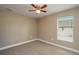 Bright bedroom with neutral walls, carpet flooring and ceiling fan at 1021 Rhodes S Rd, Haines City, FL 33844