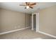 Simple bedroom with neutral walls, carpet flooring and a ceiling fan at 1021 Rhodes S Rd, Haines City, FL 33844