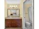 Bathroom with wood vanity, large mirror and shower/tub combo at 4241 Oak Loop # 36, Mulberry, FL 33860