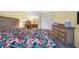 Spacious bedroom with large dresser and tropical print bedding at 4241 Oak Loop # 36, Mulberry, FL 33860