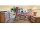 Main bedroom with a king bed, dresser, and private patio access at 4241 Oak Loop # 36, Mulberry, FL 33860