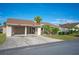 Tan two-story home with carport and landscaped yard at 4241 Oak Loop # 36, Mulberry, FL 33860
