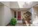 Condo entrance with a red door and manicured plants at 4241 Oak Loop # 36, Mulberry, FL 33860
