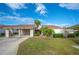 Tan two-story home with carport and landscaped yard at 4241 Oak Loop # 36, Mulberry, FL 33860