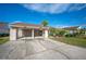 Tan two-story home with carport and landscaped yard at 4241 Oak Loop # 36, Mulberry, FL 33860
