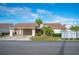 Tan two-story home with carport and landscaped yard at 4241 Oak Loop # 36, Mulberry, FL 33860
