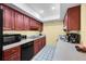 Kitchen boasts dark wood cabinets, black appliances, and ample counter space at 4241 Oak Loop # 36, Mulberry, FL 33860