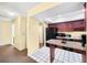 Well-equipped kitchen featuring dark wood cabinets, black appliances, and a breakfast bar at 4241 Oak Loop # 36, Mulberry, FL 33860