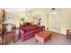 Open living space with red couch, coffee table, and dining area at 4241 Oak Loop # 36, Mulberry, FL 33860