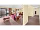 Living room with red couch, patio access, and dining area view at 4241 Oak Loop # 36, Mulberry, FL 33860