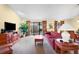 Bright living room with red sofa and access to a patio at 4241 Oak Loop # 36, Mulberry, FL 33860