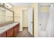 Second bathroom with double vanity and a view of the hallway at 4243 Oak Loop # 35, Mulberry, FL 33860