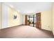 Bright bedroom with carpeting, sliding glass doors, and access to a patio at 4243 Oak Loop # 35, Mulberry, FL 33860