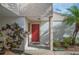 Condo building exterior with a red door and landscaping at 4243 Oak Loop # 35, Mulberry, FL 33860