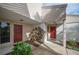 Condo building exterior showcasing two red doors and landscaping at 4243 Oak Loop # 35, Mulberry, FL 33860
