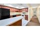 Kitchen boasts dark wood cabinets and black appliances at 4243 Oak Loop # 35, Mulberry, FL 33860