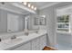 Bathroom with double vanity, tile flooring, and a shower at 809 Fairlane Dr, Lakeland, FL 33809
