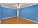 Blue-walled bedroom with wood floors and a ceiling fan at 809 Fairlane Dr, Lakeland, FL 33809