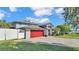 Home exterior showcasing a red garage door and a paved driveway at 809 Fairlane Dr, Lakeland, FL 33809