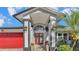 Inviting home exterior with a red door and landscaped entryway at 809 Fairlane Dr, Lakeland, FL 33809
