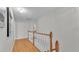 Upper hallway with wood floors and white railing at 809 Fairlane Dr, Lakeland, FL 33809