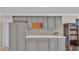 Kitchen wet bar with gray cabinets and wine rack at 809 Fairlane Dr, Lakeland, FL 33809