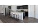 Modern kitchen with dark cabinetry, granite countertops, and stainless steel appliances at 3527 Fernanda Dr, Deltona, FL 32738