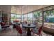 Relaxing screened porch with patio furniture and view of backyard at 2200 S Peninsula Dr, Daytona Beach, FL 32118