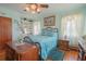 Bedroom with teal bedding, hardwood floors, and ceiling fan at 2200 S Peninsula Dr, Daytona Beach, FL 32118