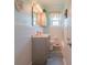 Clean bathroom with white tiled walls, gray vanity, and a tub shower combo at 2200 S Peninsula Dr, Daytona Beach, FL 32118