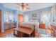 Bedroom with floral bedding, hardwood floors, and ceiling fan at 2200 S Peninsula Dr, Daytona Beach, FL 32118