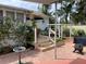 Charming backyard with patio, deck, and lush landscaping at 607 N Dixie Fwy, New Smyrna Beach, FL 32168