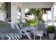 Inviting front porch with wicker furniture and lush greenery at 607 N Dixie Fwy, New Smyrna Beach, FL 32168