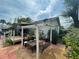 Charming backyard with pergola, patio, and hanging swing at 607 N Dixie Fwy, New Smyrna Beach, FL 32168