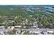 Aerial view showing home's location in a residential neighborhood near water at 607 N Dixie Fwy, New Smyrna Beach, FL 32168