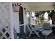 Relaxing front porch with striped chairs and side table at 607 N Dixie Fwy, New Smyrna Beach, FL 32168
