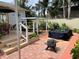 Backyard oasis with patio, fire pit, hot tub, pergola, and lush landscaping at 607 N Dixie Fwy, New Smyrna Beach, FL 32168