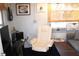 Comfortable home office with a recliner, computer, and ample workspace at 607 N Dixie Fwy, New Smyrna Beach, FL 32168