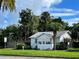 Home's exterior showcasing a charming front porch at 607 N Dixie Fwy, New Smyrna Beach, FL 32168