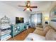 Living room with a sofa, TV, and decorative shelving at 603 N Pine St, New Smyrna Beach, FL 32169