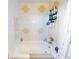 Bathroom with shower/tub, updated tile, and convenient shelving at 603 N Pine St, New Smyrna Beach, FL 32169