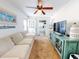 Living area with a couch, TV, and view into the kitchen at 603 N Pine St, New Smyrna Beach, FL 32169