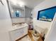 Bathroom with vanity, toilet, and decorative shelving at 603 N Pine St, New Smyrna Beach, FL 32169