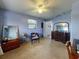 Bright bedroom featuring a dresser, chair, and mirror at 603 N Pine St, New Smyrna Beach, FL 32169