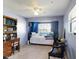 Relaxing bedroom with twin bed, desk and window at 603 N Pine St, New Smyrna Beach, FL 32169